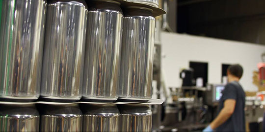 aluminum cans in a conveyor belt during production