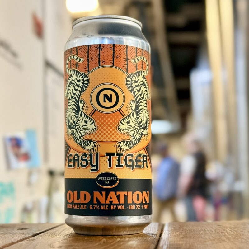 An aluminum can of Old Nation Easy Tiger West Coast IPA beer sitting on a table.
